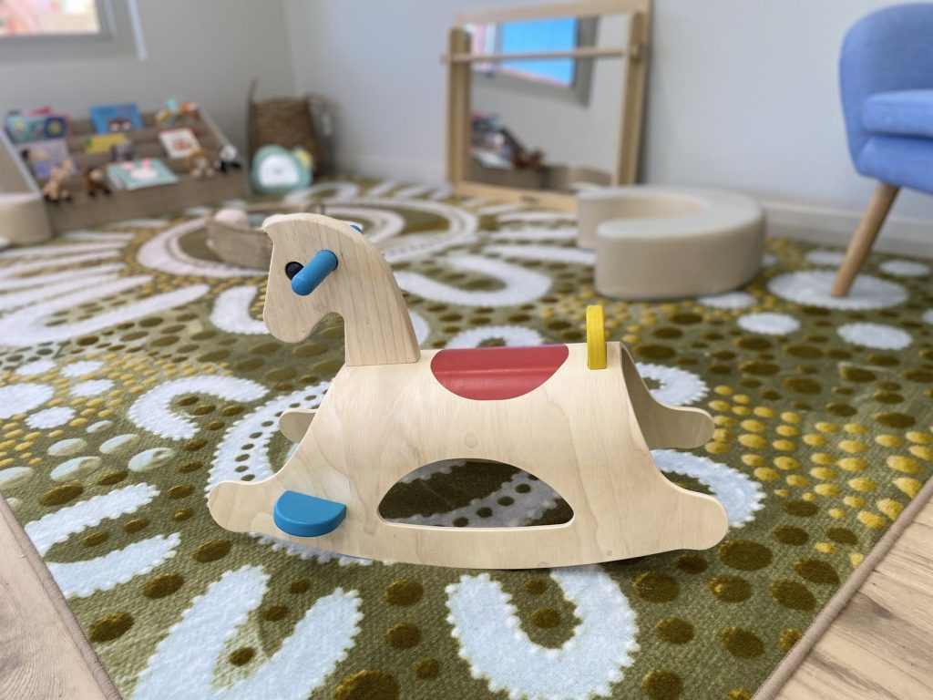 Wooden rocking horse in a Bloom room