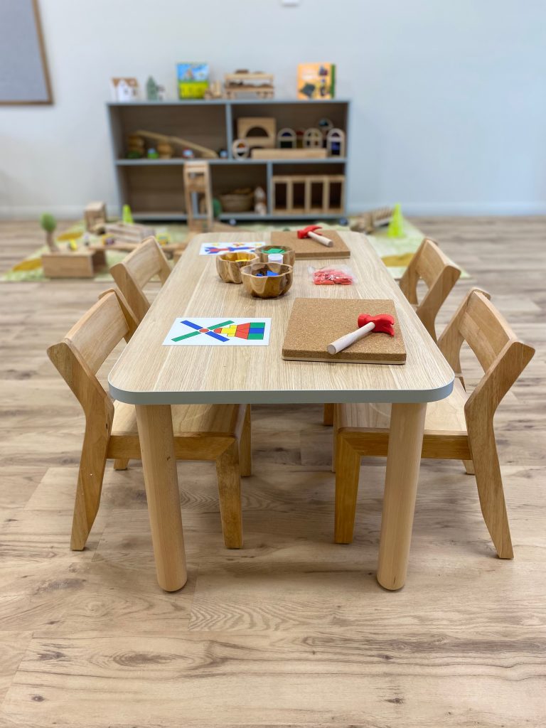 Activity table set up with wooden shapes and tools