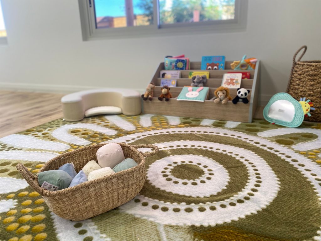 Nursery room with books, soft toys and baskets
