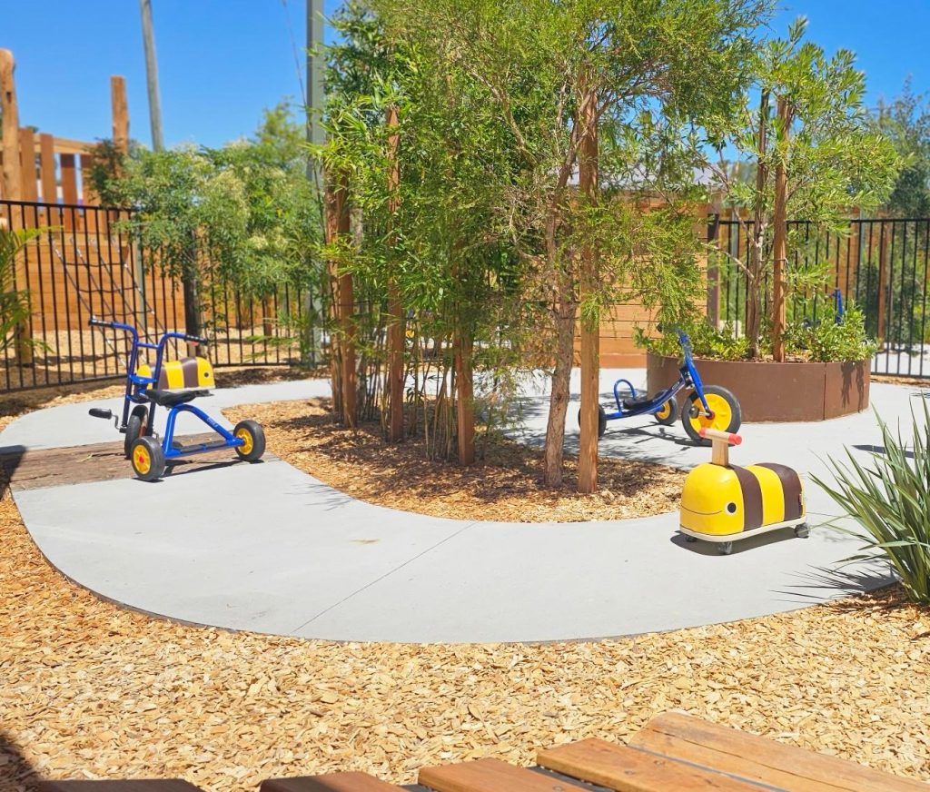 Outdoor bike path and native planting in the Bloom playground