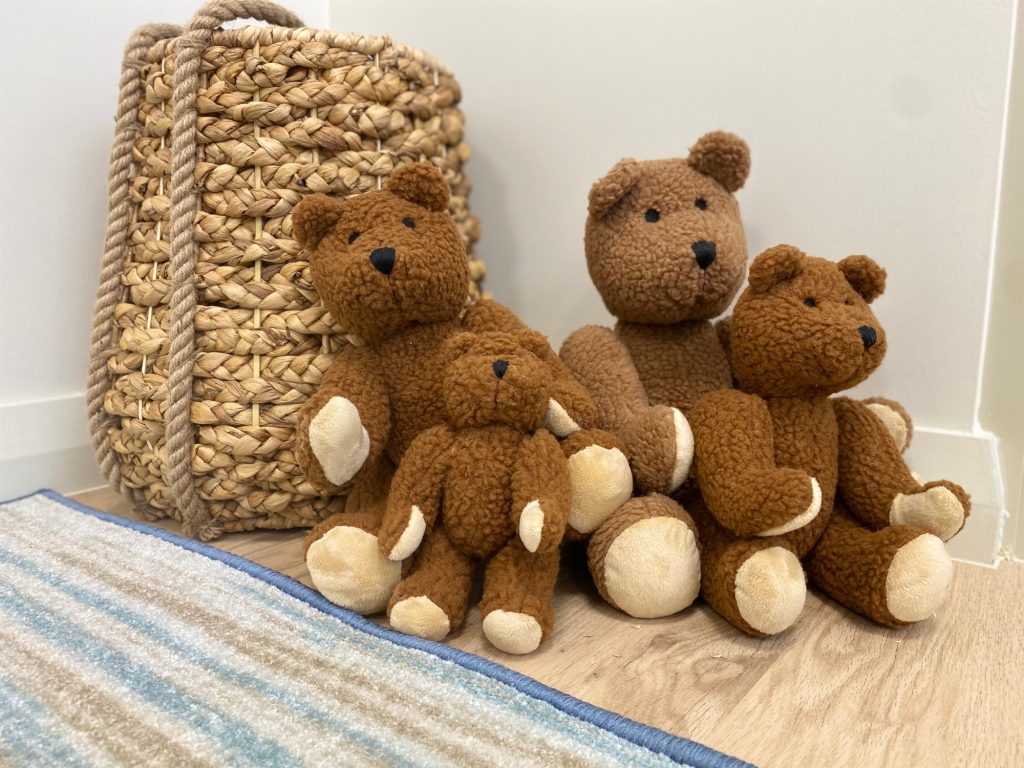 Teddy bears beside a woven basket